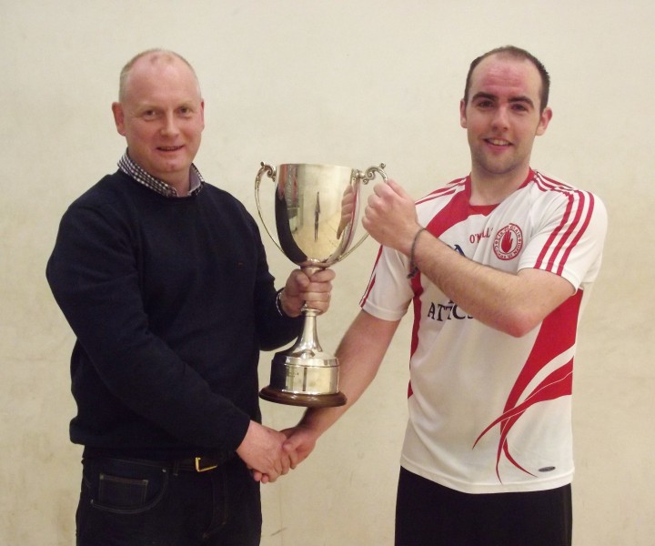 Barry Devlin receives the Hugh Duff Cup from county chairman Paul Allison